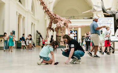 Children exploring dinosaur exhibit at Chicago's Field Museum.