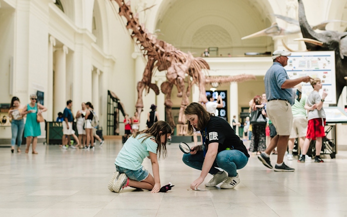 Children exploring dinosaur exhibit at Chicago's Field Museum.