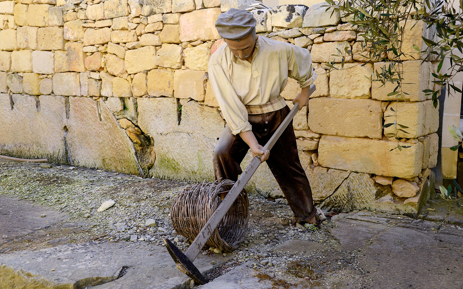 Worker demonstrating traditional stone cutting at Limestone Heritage, Malta.
