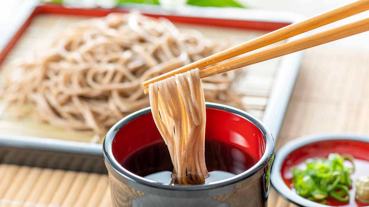 Soba noodles being dipped in sauce