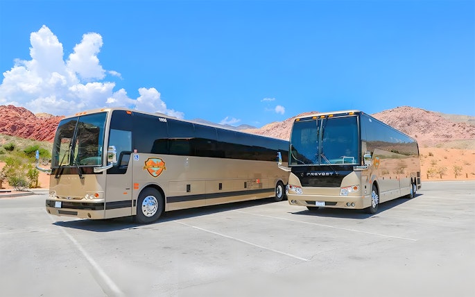 Tour buses parked at a scenic stop during a Las Vegas to Grand Canyon West and Hoover Dam tour.