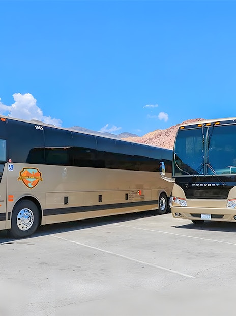 Tour buses parked at a scenic stop during a Las Vegas to Grand Canyon West and Hoover Dam tour.
