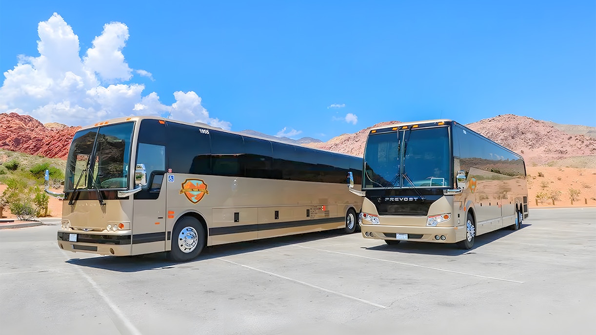 Group of tourists enjoying the view of the Grand Canyon West and Hoover Dam on a sunny day during a bus tour from Las Vegas