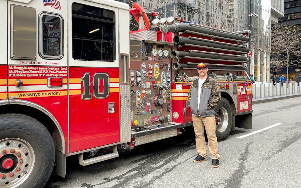 FDNY Engine 10 parked on a New York City street with a person standing beside it.