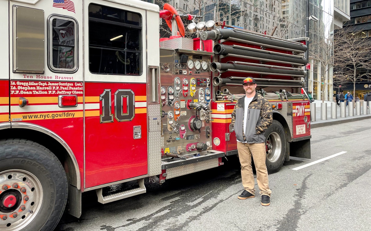 FDNY Engine 10 parked on a New York City street with a person standing beside it.