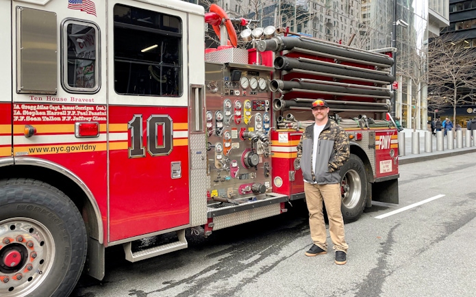 FDNY Engine 10 parked on a New York City street with a person standing beside it.