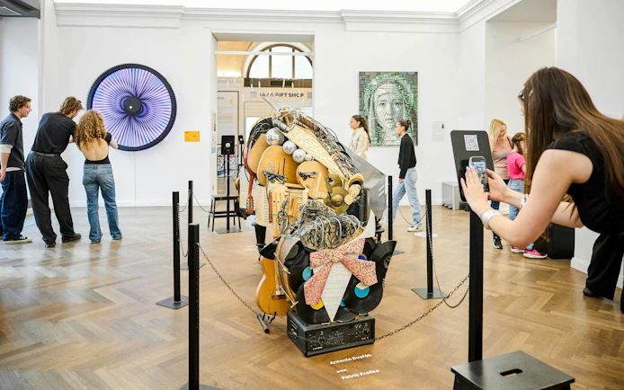 Visitors exploring exhibits at IAM Illusion Art Museum, Prague.