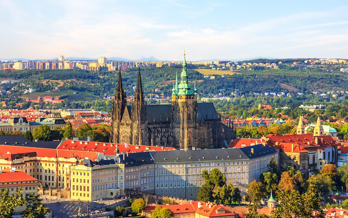 Prague Castle with St. Vitus Cathedral, view over city rooftops.