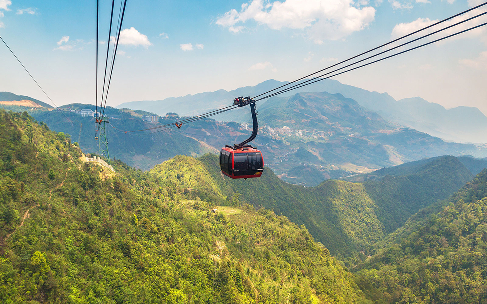 Fancipan Cable Car over lush green mountains in Sapa, Vietnam.