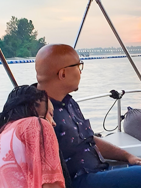 Couple enjoying sunset on a boat during Let's Go Kelong tour.
