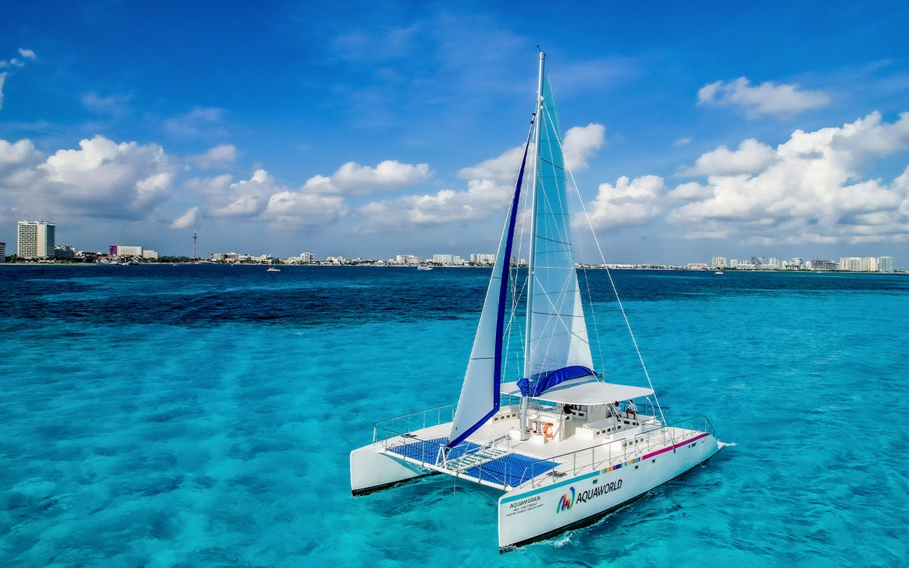Catamaran sailing on turquoise waters near Isla Mujeres, Mexico.