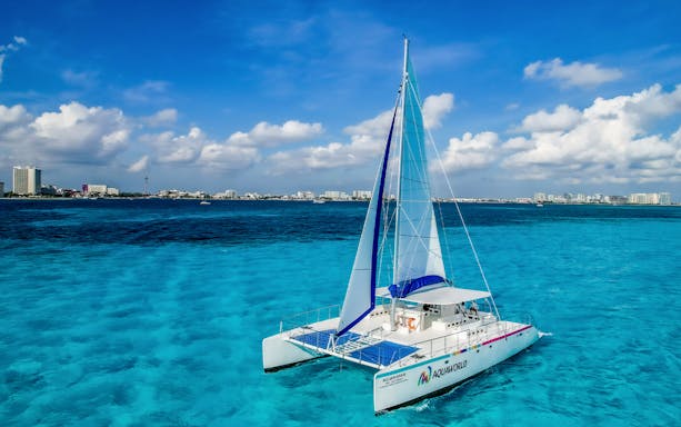 Catamaran sailing on turquoise waters near Isla Mujeres, Mexico.