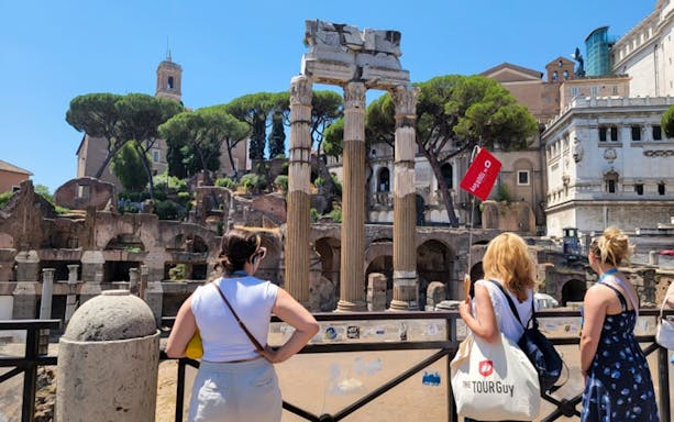 Tourists viewing ancient ruins at the Roman Forum in Rome, Italy.