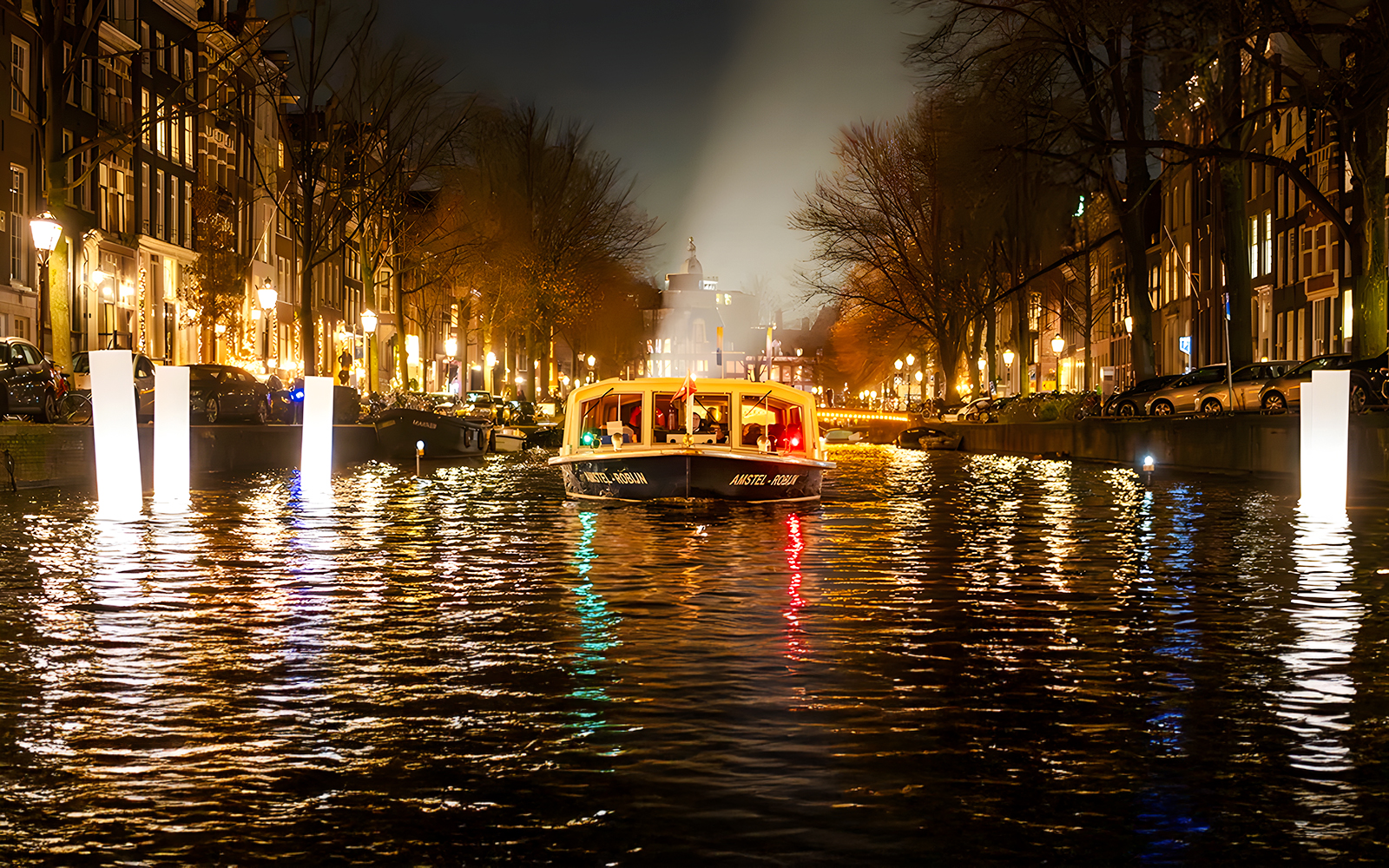 Amsterdam canal boat during Light Festival evening cruise.