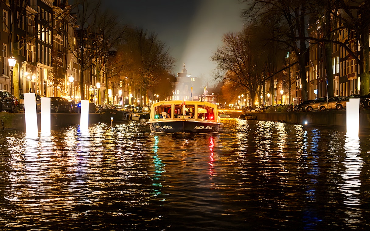Amsterdam canal boat during Light Festival evening cruise.