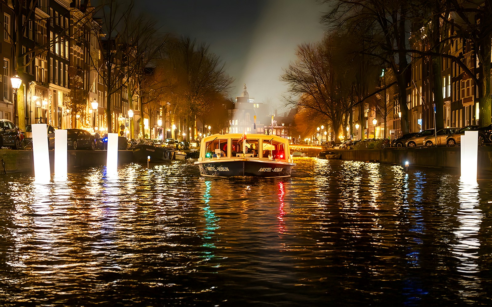 Amsterdam canal boat during Light Festival evening cruise.