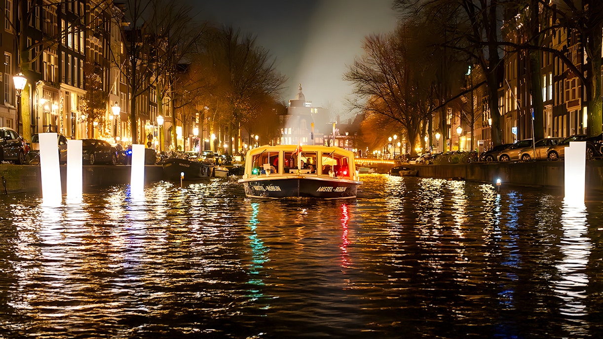 Amsterdam canal boat during Light Festival evening cruise.