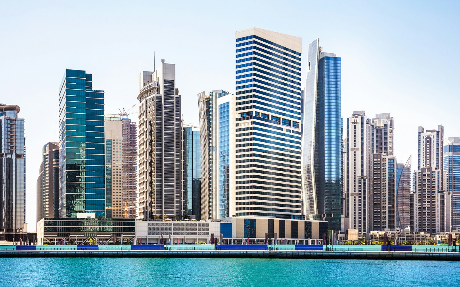 Dubai Business Bay skyline with modern skyscrapers along the waterfront.