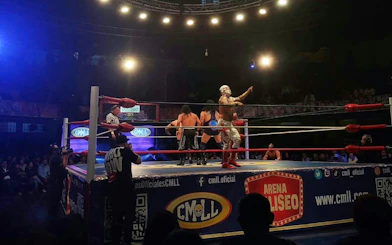 Wrestlers performing in a match at Lucha Libre Arena Mexico.