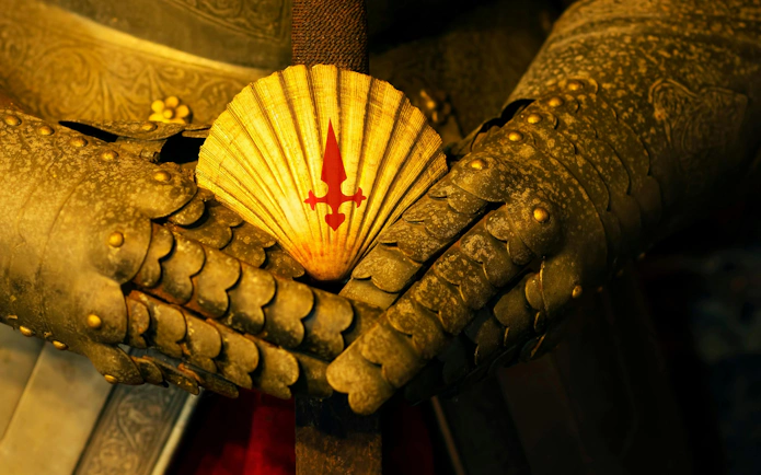 Scallop shell with red cross on sword hilt, medieval armor, Camino de Santiago, Spain.