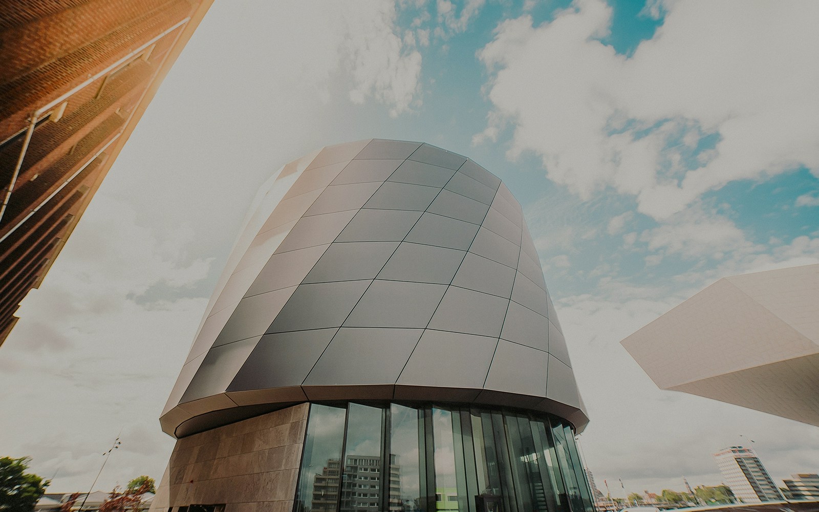 Modern architecture of This is Holland building in Amsterdam under a blue sky.