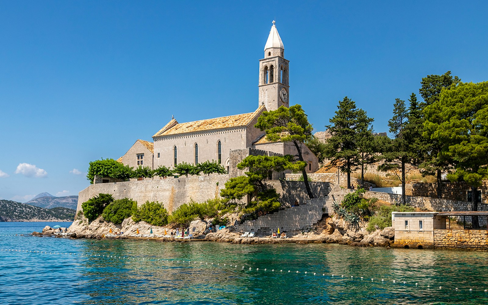 Historic church on Lopud Island, Elaphiti Islands, Croatia, with coastal view.