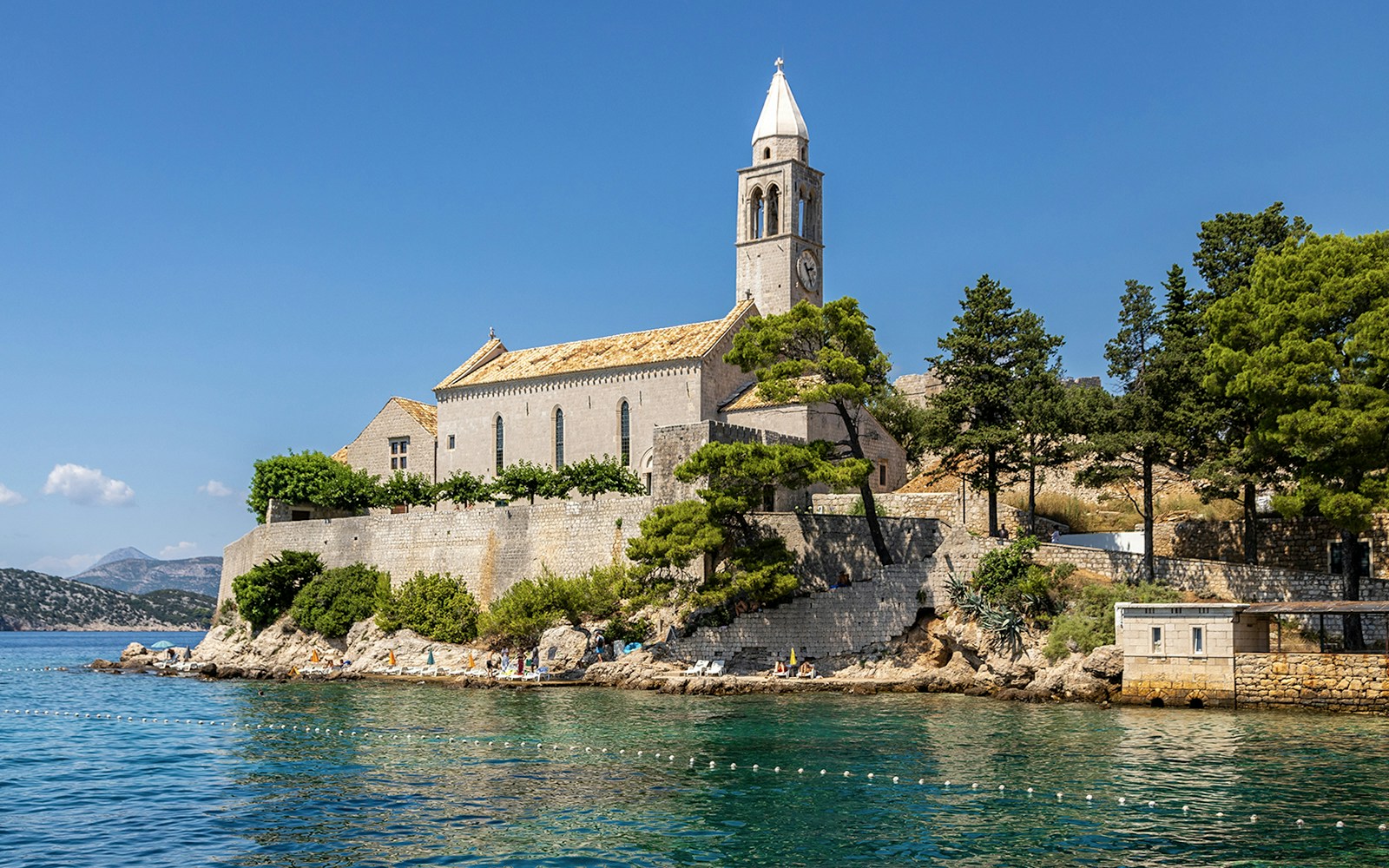 Historic church on Lopud Island, Elaphiti Islands, Croatia, with coastal view.