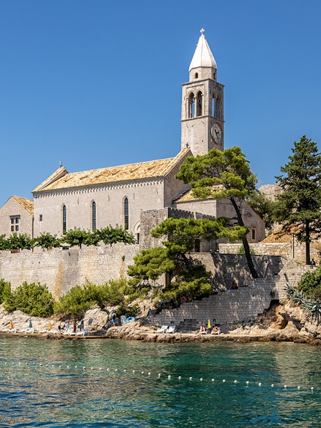 Historic church on Lopud Island, Elaphiti Islands, Croatia, with coastal view.