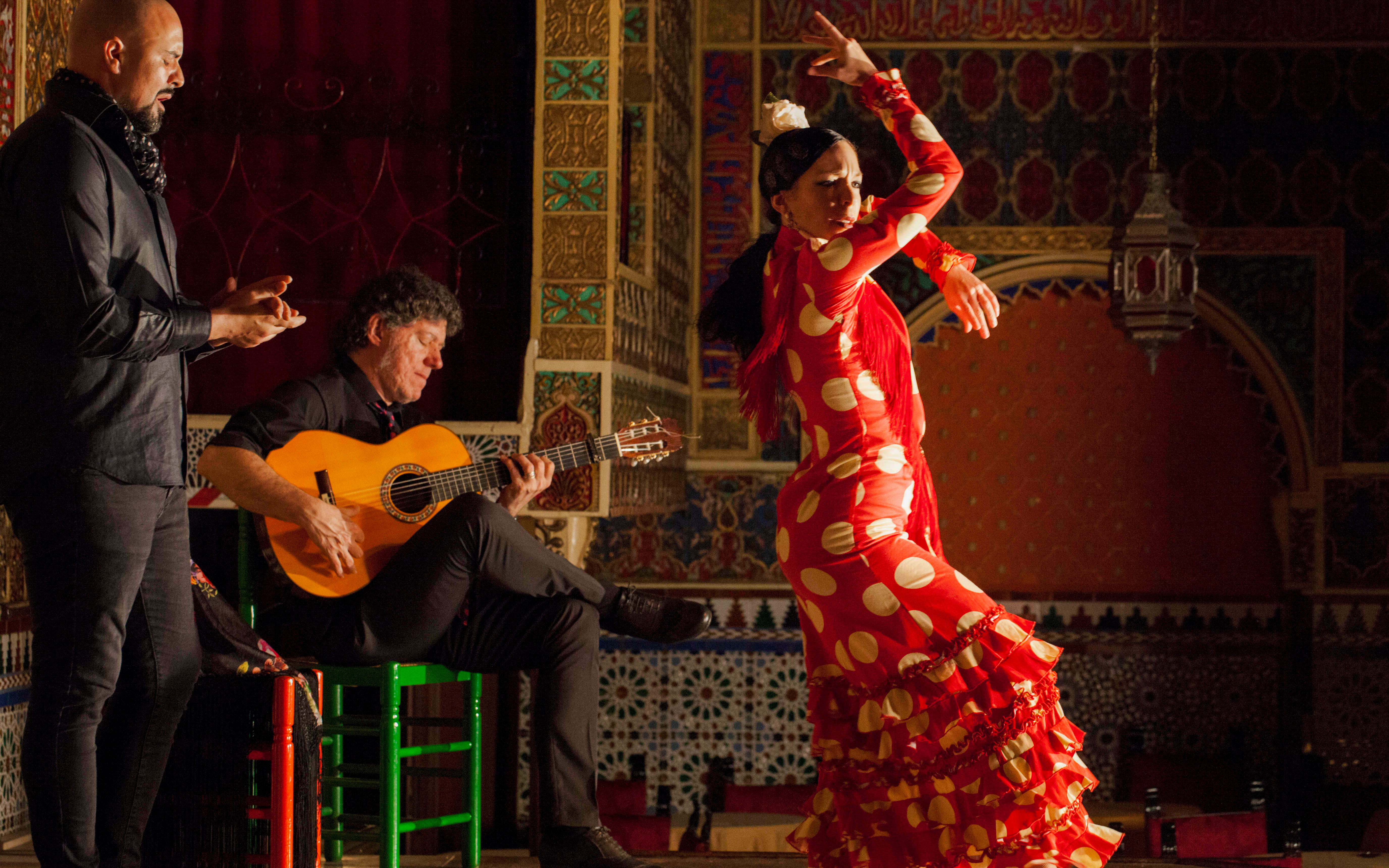 Flamenco dancer performing with guitarist and singer at Torres Bermejas, Madrid.