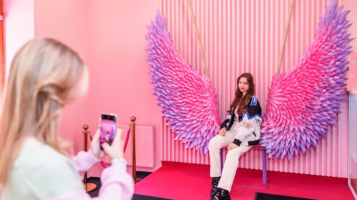 Tourist taking photographs in Be Happy Museum Warsaw