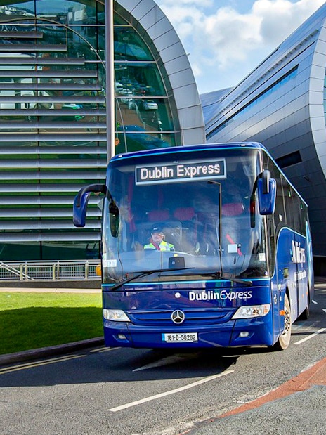 Dublin Express bus at Dublin Airport terminal.
