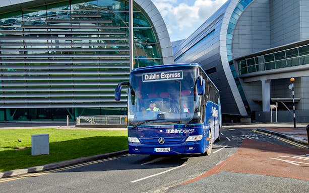 Dublin Express bus at Dublin Airport terminal.