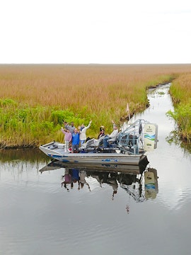 Tourists on an airboat exploring Everglades at Sawgrass Recreation Park.
