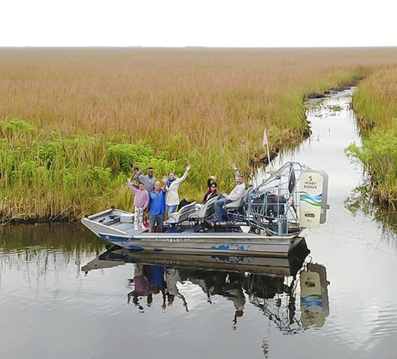 Tourists on an airboat exploring Everglades at Sawgrass Recreation Park.