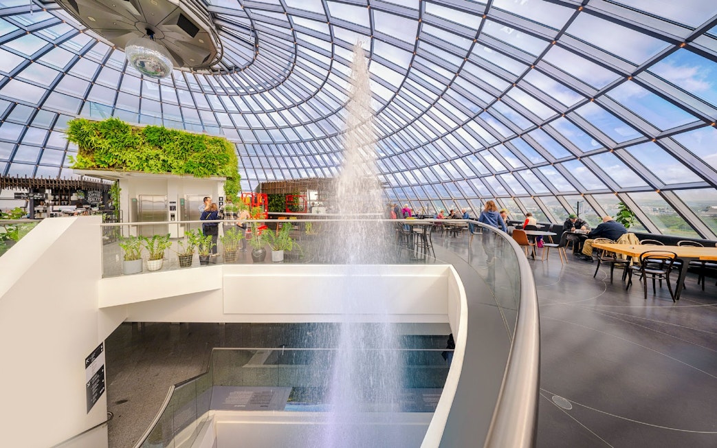 Guests exploring exhibits inside Perlan Museum's glass dome in Reykjavik.