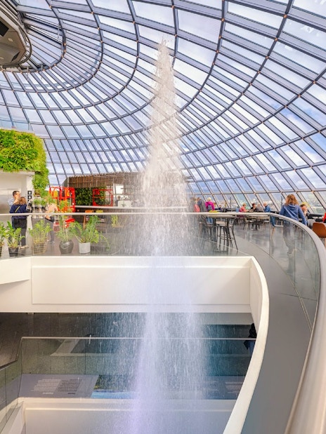 Guests exploring exhibits inside Perlan Museum's glass dome in Reykjavik.