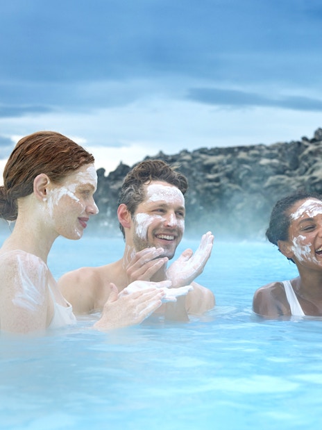 Tourists applying silica mud at Blue Lagoon Geothermal Pool, Iceland.