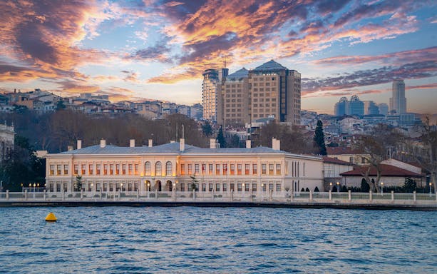 Bosphorus waterfront view with historic building at sunset, Istanbul.