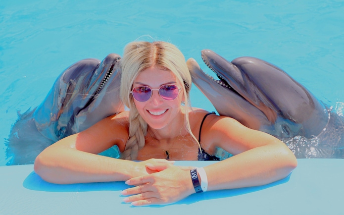 Woman with dolphins at Hurghada Dolphin Show, Egypt Dolphin World.