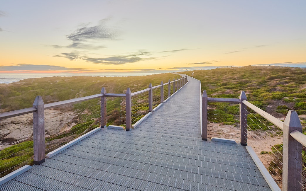Walkway leading to lighthouse on Rottnest Island at sunset.