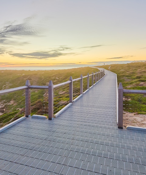 Walkway leading to lighthouse on Rottnest Island at sunset.