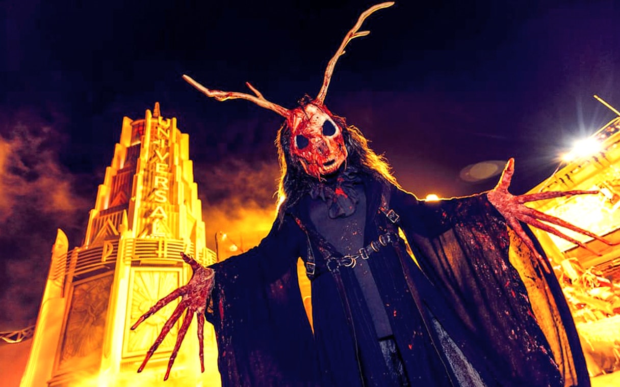 Halloween character with antlers at Universal Studios Hollywood entrance during Halloween Horror Nights.