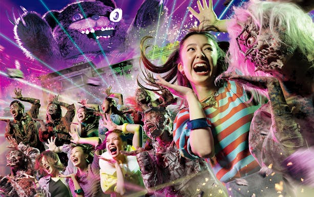 Visitors react to zombies and special effects at Halloween Horror Night, Universal Studios Japan.