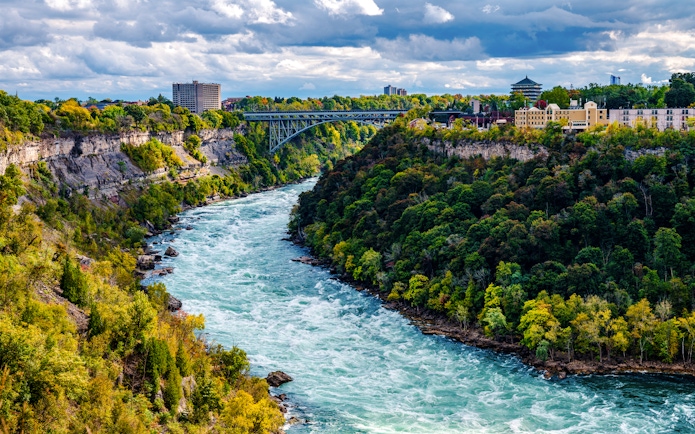 Niagara River flowing through Niagara Gorge with Whirlpool Rapids Bridge in the background.