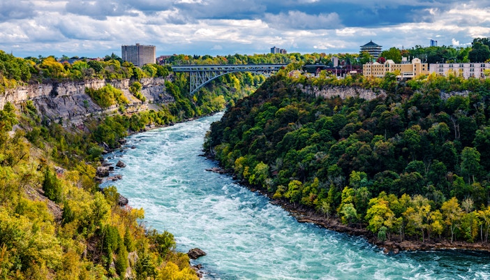 Niagara River flowing through Niagara Gorge with Whirlpool Rapids Bridge in the background.