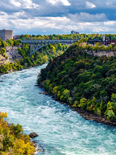 Niagara River flowing through Niagara Gorge with Whirlpool Rapids Bridge in the background.