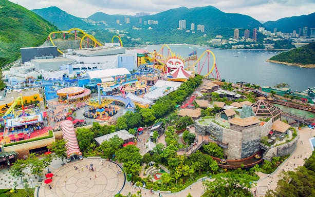 Aerial view of Ocean Park Hong Kong with roller coasters and waterfront.