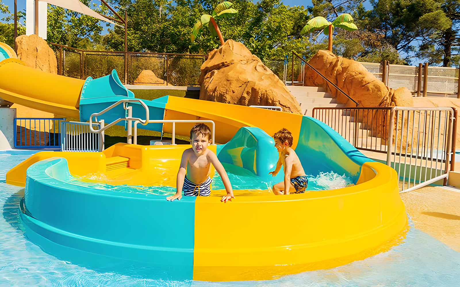 Kids playing on Mini Turbolance slide at Aquopolis Villanueva de la Cañada.