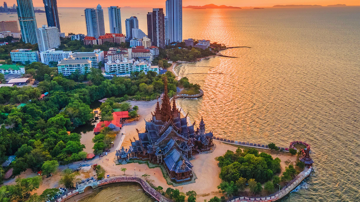 Aerial view of the Sanctuary of Truth in Pattaya, Thailand, with surrounding coastline and cityscape.