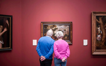 Visitors viewing artwork at Groeningemuseum, Bruges.
